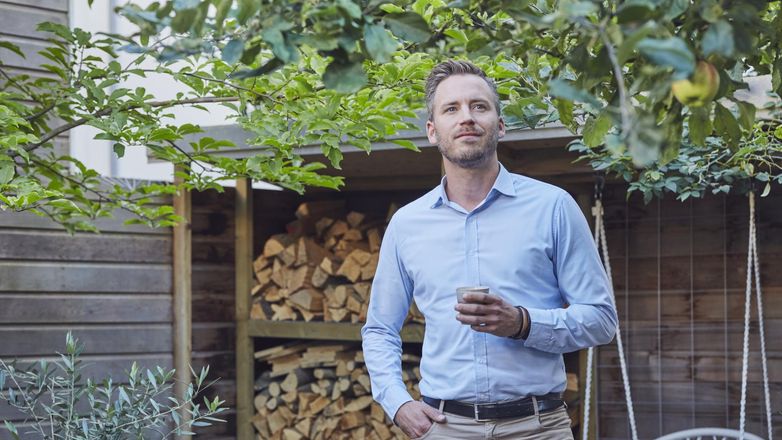 Man outside with cup of coffee