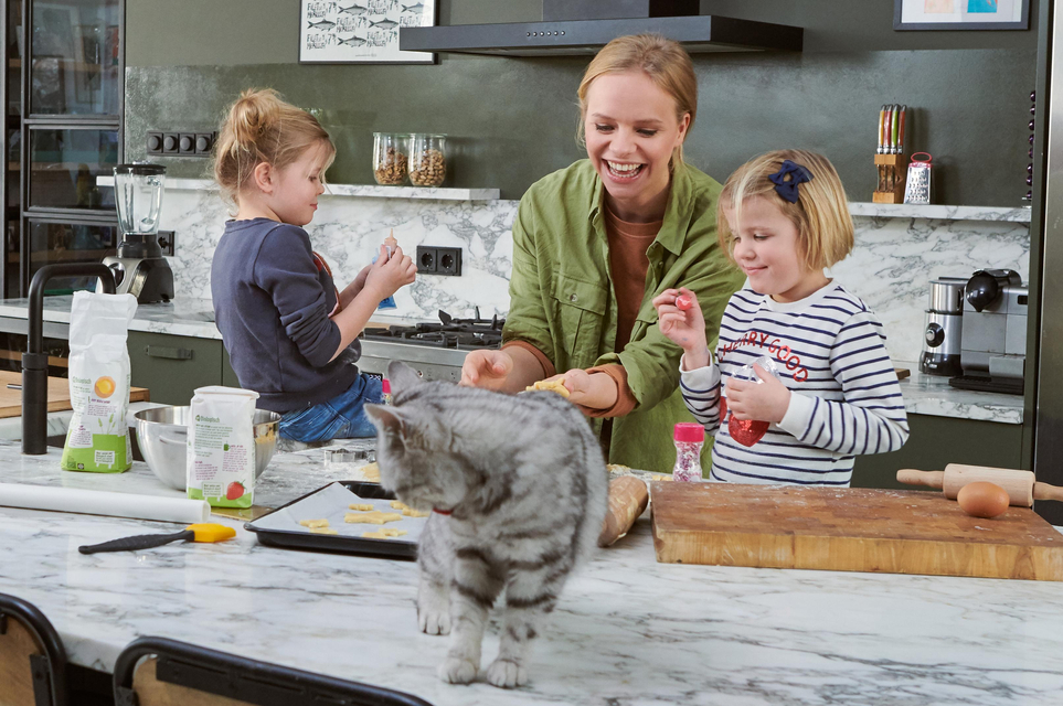 Mother in the kitchen with her children