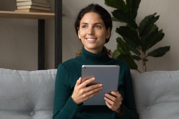 Woman on couch with tablet